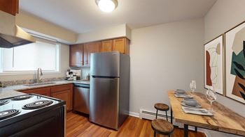 a kitchen with stainless steel appliances and a wooden table